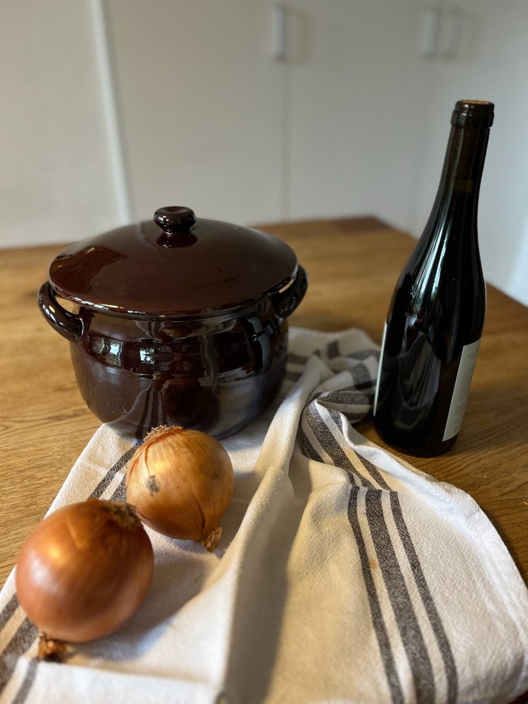 tureen onions and bottle of wine